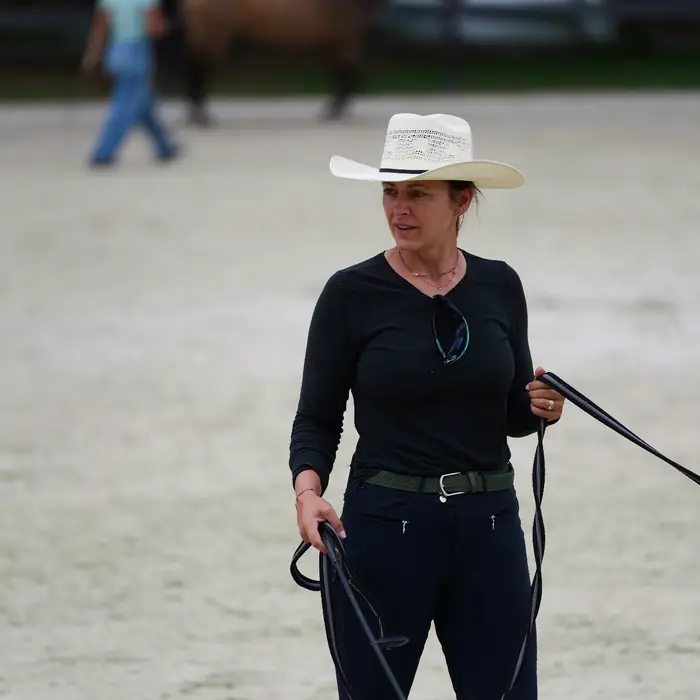 Trainer working a horse on the line