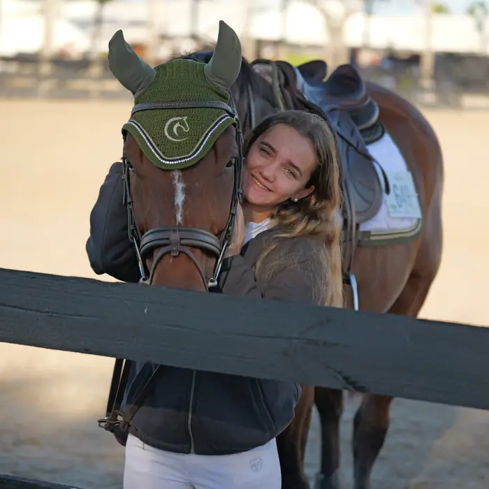 Rider hugging her horse at the show